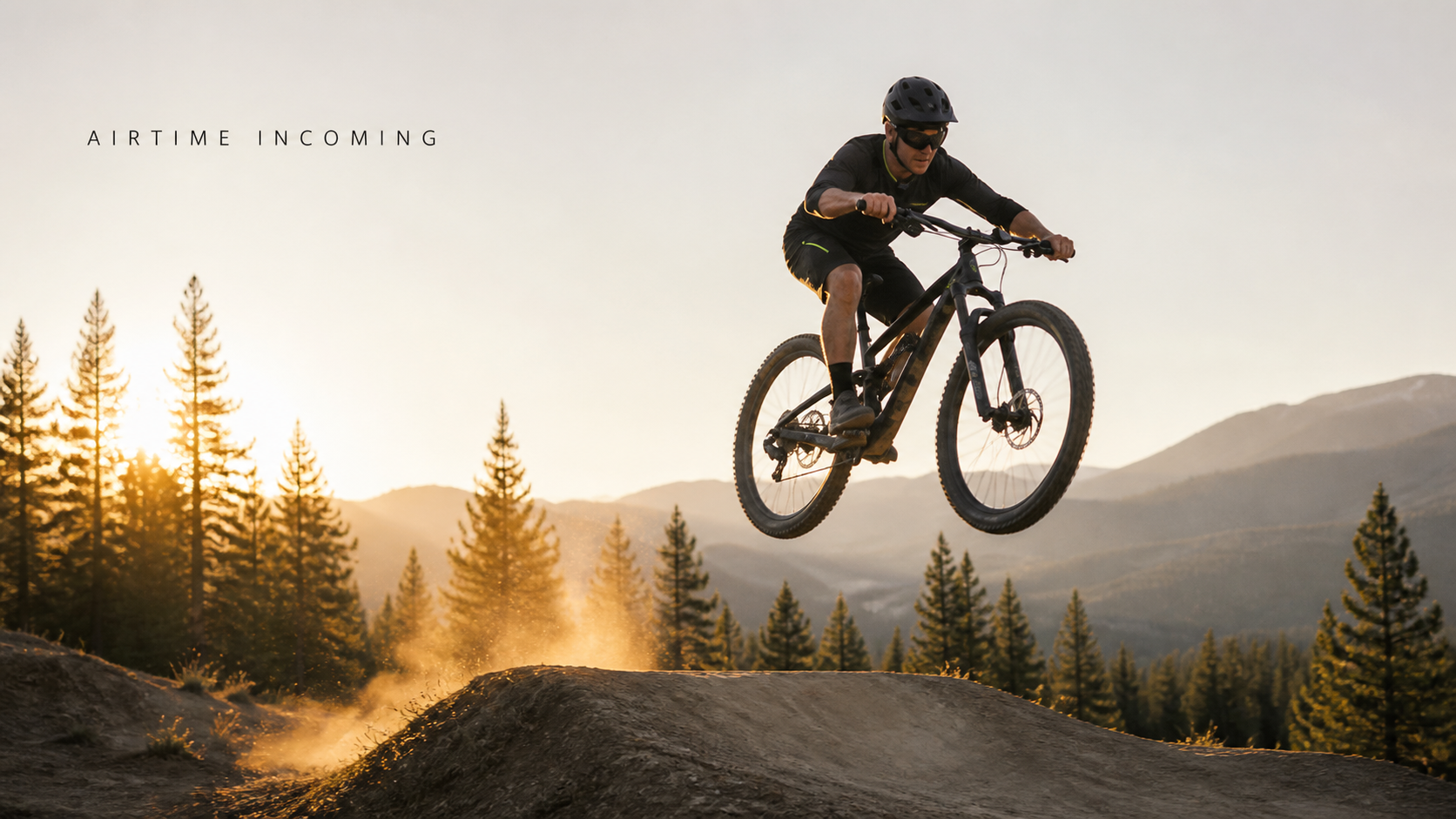 Mountain biker taking off from a dirt jump with both wheels airborne